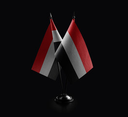 Small national flags of the Yemen on a black background