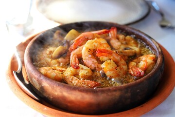 Shrimps on frying pan with lemon. Close up.
