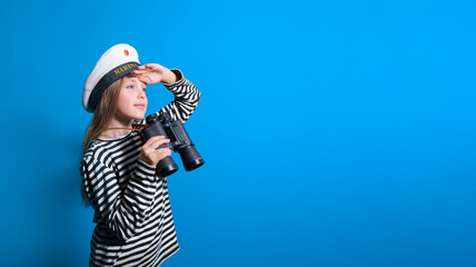 Banner of a sailor girl on a blue background teenage girl in a sailor suit with a binocular looking into the distance - obrazy, fototapety, plakaty