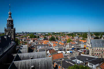 Fototapeta premium A view from the top of Saint Johns Church in Gouda looking out over the rooftops of the pretty town on a sunny summer day. The gothic building is a stunning attraction for tourists in the Netherlands