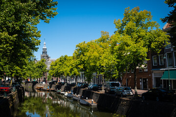Fototapeta premium typical dutch, canal, flowers, tree, outdoor, city, tourism, architecture, building, built up, centre, clear, daytime, dutch, europe, european, gouda, government, green, historic, holland, house, neth