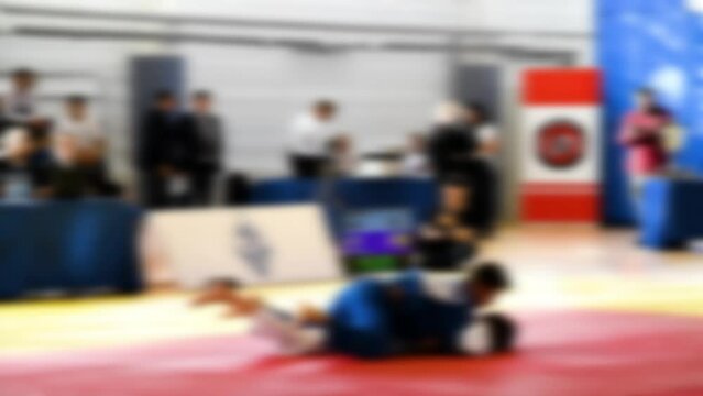 Judo competitions. Young athletes compete on the tatami. Judo. Blurred.