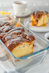 Homemade bread pudding with chocolate chips on a gray concrete background. Selective focus, copy space.