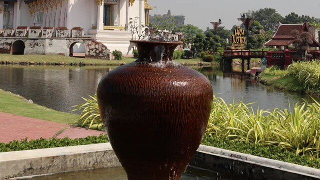 Pottery or vase fountain, water falling into the clay vase. Ancient City Mueang Boran in Samut Prakan, Thailand.