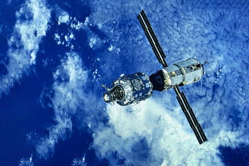 Russian spaceship over the surface of the Earth. Elements of this image furnished by NASA