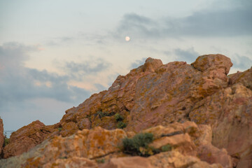 Moon and rocks during the sunset