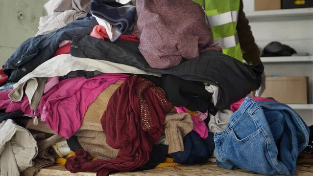 Textile recycling center. Old clothes sorting and recycling plant. Used clothing, shoes and accessories