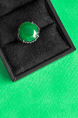 Ring in a box on green background