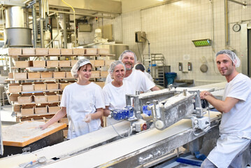 Worker in a large bakery - industrial production of bakery products on an assembly line