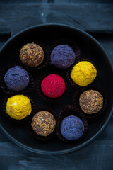 Sweets multicolored round on old wooden background