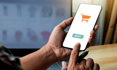 Man with phone. Online payment. Male hand using smartphone and laptop computer to shop online. Payment detail page display online trading