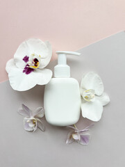 Fototapeta na wymiar Packaging for cosmetic products with g orchid flowers.