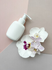 Fototapeta na wymiar Packaging for cosmetic products with g orchid flowers.