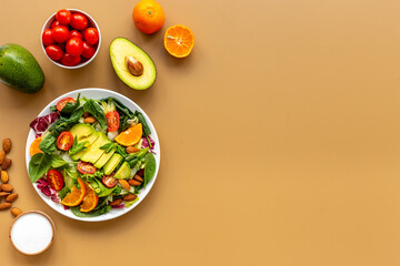 Vegan meal with healthy green salad - avocado and tomatoes in bowl
