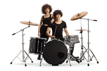 Male and female drummers posing with a drum kit