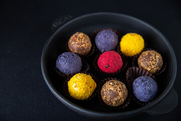 Sweets multi-colored round on a dark concrete background