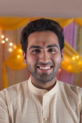 Young man with beard / stubble - wearing kurta pyjama with smiling face. Indian man wearing kurta...