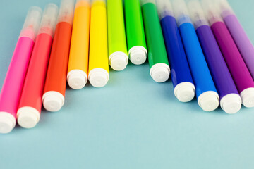 Multi-colored pencils in a glass cup on a white table. Back to school. Background with colored wooden pencils and copy space. High quality photo