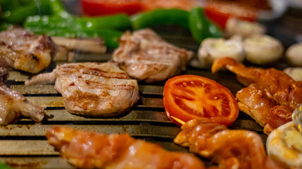 Barbecue vegetables and meat chicken, beef and cutlets front view