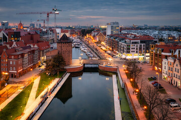 Old town in Gdansk with the Granaries Island by the Motlawa river at dusk, Poland.