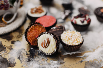 Small chocolate candies on colorful tray