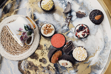 Small chocolate candies on colorful tray