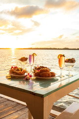 Thai cuisine set with a waterfront restaurant at sunset. - 560660191