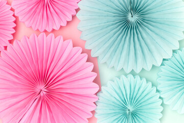 Tissue paper fans in a pink and blue colors. Gender reveal party concept.