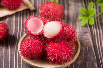fresh ripe rambutan fruit on wooden table