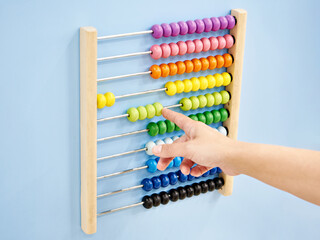 Hand and colored kids learning abacus