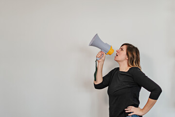 angry woman shouting upwards through a loudspeaker