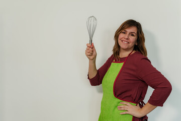 smiling woman holding a stick blender
