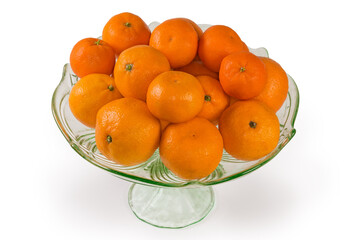 Tangerines in vintage glass fruit vase on a white background