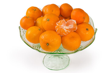 Tangerines in vintage glass fruit vase on a white background