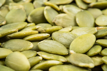 Green fresh peeled pumpkin seeds. Extremely close shot