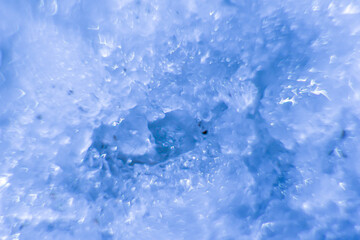 abstract blurred background of snowflakes of blue color with copy space