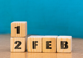 Cube shape calendar for February 12 on wooden surface with empty space for text,cube calendar for december on wood background