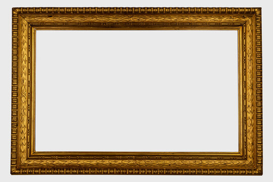 Antique golden frame isolated on white background. Old wooden frame with floral carvings painted with gold paint. Italian heritage and antiquities