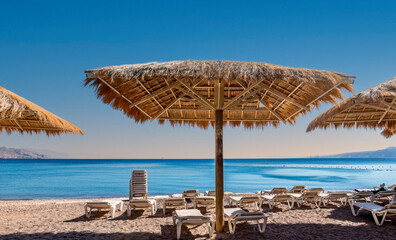 Relaxing atmosphere at the central public beach in Eilat - famous tourist resort city in Israel. Concept of healthy and happy vacation