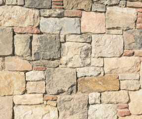 Masonry of ancient stones with uneven texture