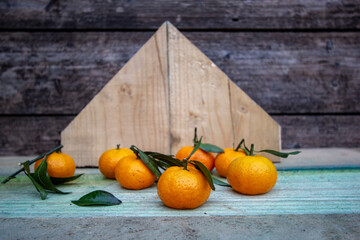 juicy fresh small tangerines on a wooden background