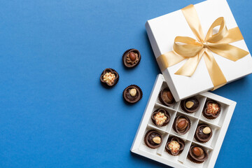 White box with chocolates candies and golden tape. top view with copy space