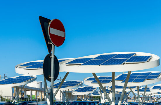solar power plant with big antennas on a parking for charging electrocars, problems of car energy of future