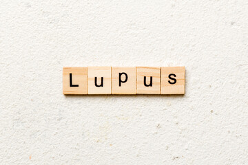 lupus word written on wood block. lupus text on table, concept