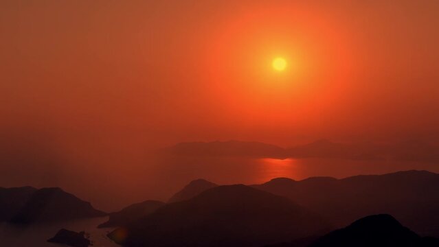 Misty golden sunset over the sea and islands. Tropical evening landscape. Zoom in