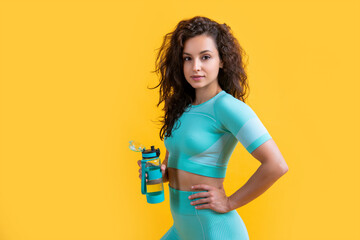 fitness athlete with sport water bottle in studio. fitness athlete hold sport water bottle