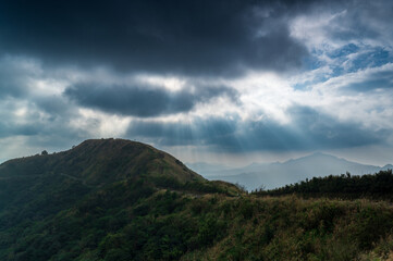 Obraz na płótnie Canvas Watch the romantic Crepuscular Ray (cloud gap light) on the mountain. Buyan Pavilion, Shuangxi District, New Taipei City. Taiwan