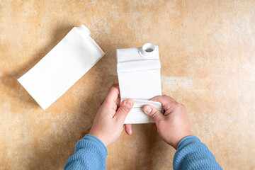 Person folds long-life packaging to be recycled. High quality photo