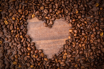 Heart shape made from coffee beans. Drink and morning energy concept