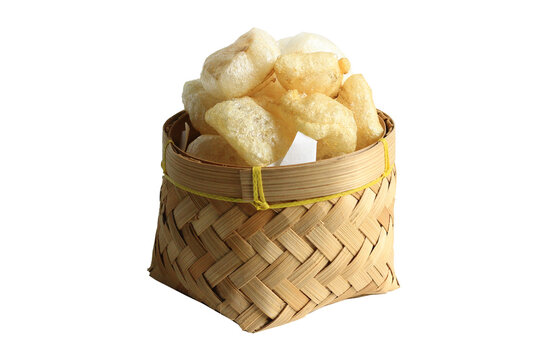 Rambak or Karupuak Jangek or Kerupuk Kulit  is a Indonesian Traditional Cattle or Cow Skin Cracker. Rambak in besek, isolated on white background.